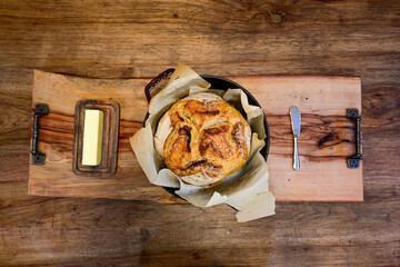 Sourdough and butter on wooden serving tray