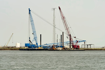Industrial Marine Construction Site with Large Cranes on Floatin