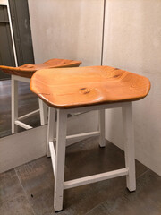 Wooden chair with minimalist design in a modern setting.