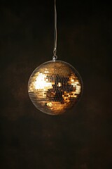 Golden Disco Ball Hanging Against a Dark Background