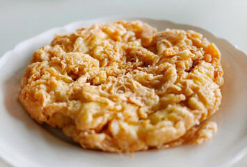 Deep fried crab omelette Thai style, crispy, thick and oily, unhealthy cholesterol but delicious, close up shot, seafood meal in Thai local restaurant