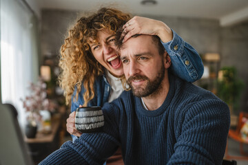 Happy couple enjoying together while browsing digital tablet screen