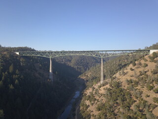 Majestic drone shot of Foresthill Bridge, California's iconic landmark, spanning the American...