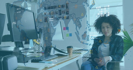 Image of financial data processing over african american businesswoman in office