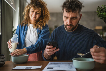 man is having breakfast and scan QR code from invoice to make payment