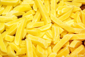 On a table, there is a generous pile of delicious yellow french fries