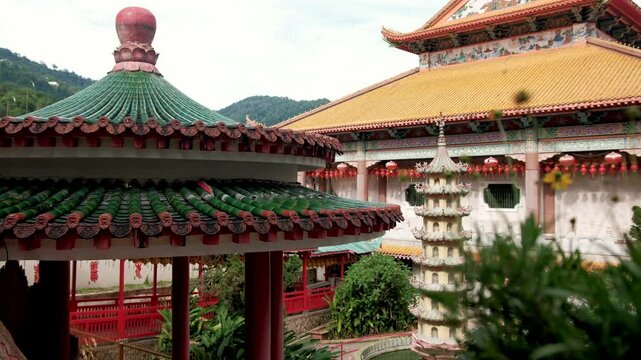 Historic kek lok si temple rooftops rising above george town skyline, featuring intricate chinese architectural ornamentation highlighting penang's cultural heritage