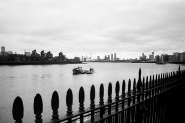 Grainy monochrome view of greenwich and the millenium dome from the river thames in london