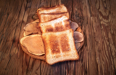 A stack of toasted bread on a wooden board. The bread is toasted and has a crispy texture. The wooden board is brown and has a natural texture. Warmth and comfort concept