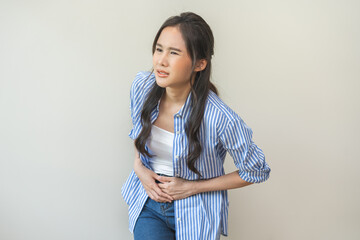 Flatulence asian young woman intolerance hand in stomach ache, suffer from food poisoning,...