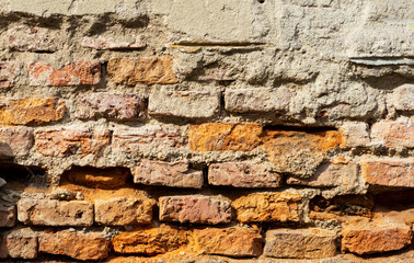 Old brickwork, with crumbling plaster