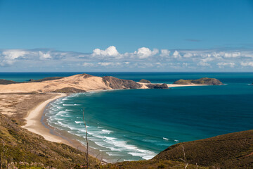 View of coastline near Cape Reinga Lighthouse (New Zealand's northern most point) with clear water and blue sky (North Island, New Zealand)