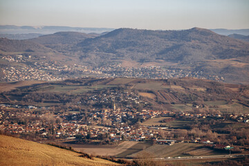 Obraz premium View from Plateau de Gergovie to Clermont-Ferrand suburbs on a winter sunset