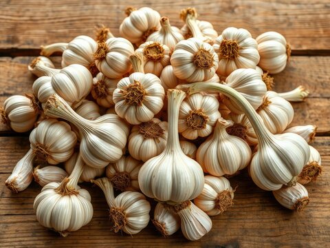 Freshly harvested garlic bulbs in a pile on a rustic wooden table, nature, farm, rural