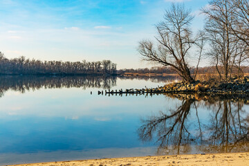 Dnipro river with trees on the banks. Landscape with wide Dnieper river on a sunny day