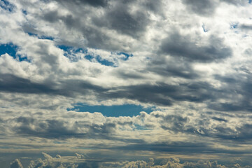 Blue sky, clouds, background, beautiful landscape with heavy thunderclouds. Nature waiting for storm