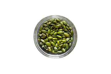 Pumpkin seeds peeled green in glass bowl isolated on white background with clipping path