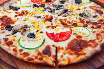 pizza with cheese, mushrooms and vegetables, selective focus