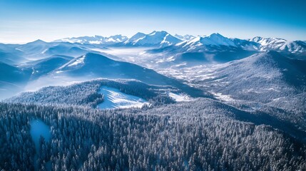 Fototapeta premium Aerial View of a Snow-Covered Mountain Range in Winter