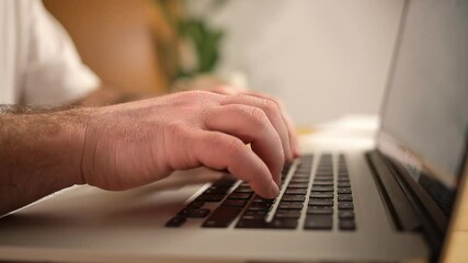 male hands typing on laptop side view
