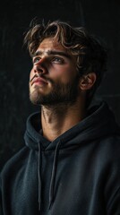 Fototapeta premium Introspective Young Man in Dark Hoodie
