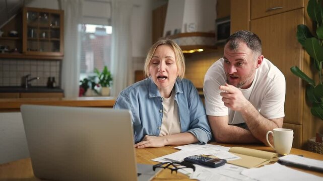 problems with finances. married couple sorting out budget while sitting in the kitchen at home