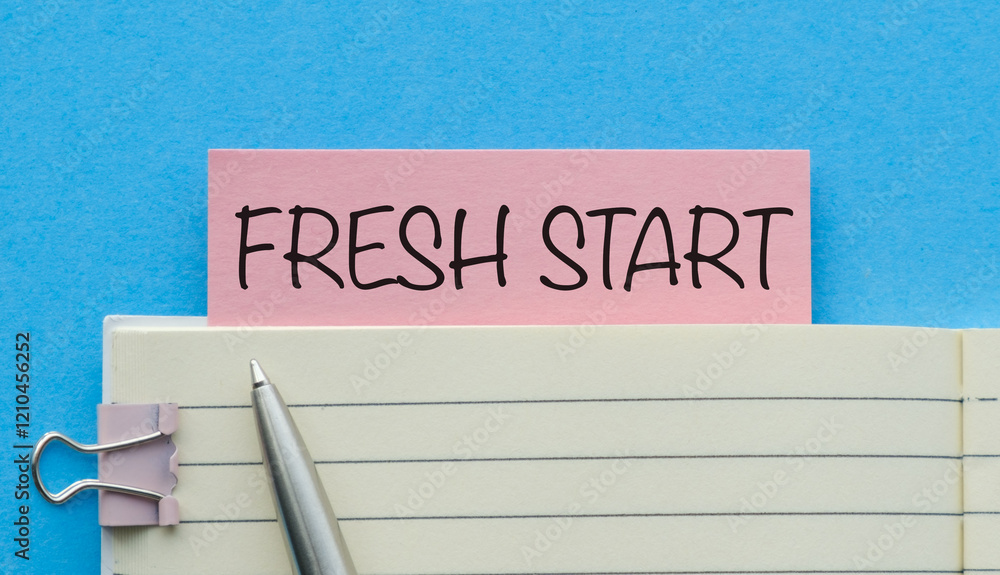 Poster a notebook with the word fresh start written on it. a pen is sitting on top of the notebook
