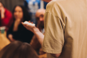 Process of playing tabletop board game on the table, fun with friends and family in room indoors, board game party concept, company group of students adults play board games, roll the dice on game map