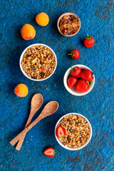 Top view of breakfast with oatmeal granola and ingredients. Healthy morning routine