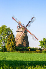 Obraz premium Old antique windmill on a meador