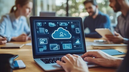 A close-up of a cloud storage dashboard on a laptop screen, showing file uploads, sync status, and collaboration tools while office workers collaborate around a table