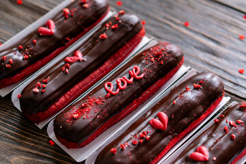 Obraz premium Delicious chocolate eclairs for Valentine's Day.