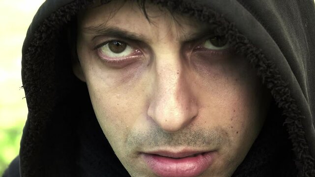 sad and lonely young man wearing a hood: problems, depression 