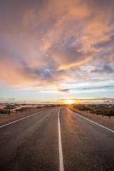 Beautiful morning on a road through the dunes. Sunrise over a road with clouds. Corralejo National...