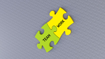 Obraz premium Team and Work text message on jigsaw puzzle. Gray background and green yellow puzzle