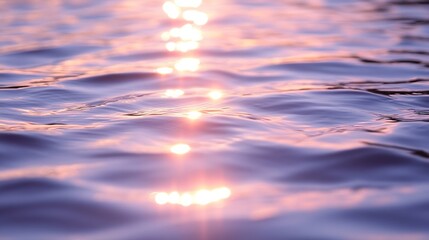 Obraz premium a body of water reflects a pink and orange sunset.