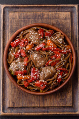 Delicious spicy Asian food soba with buckwheat noodles, beef, vegetables