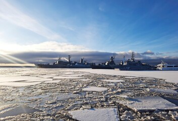 Warships are standing in the waters of the Gulf of Finland. You can see ice in the water, which...