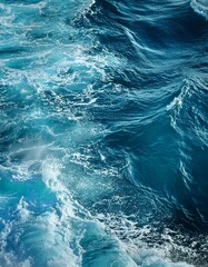 Fototapeta premium Turquoise ocean water with waves and foam.
