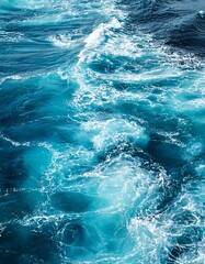 Turquoise ocean water with waves and foam.