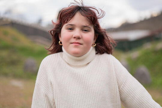 Portrait of a Young Girl in a Cozy Sweater on a Bike Day
