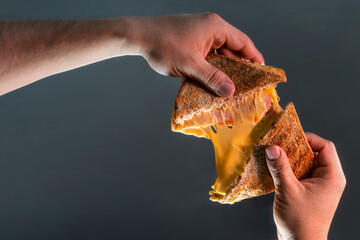 Grilled cheese sandwich pulled apart to celebrate National Grilled Cheese Month