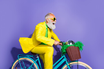 Profile side photo of cool funny man in stylish clothes riding bicycle looking empty space isolated...