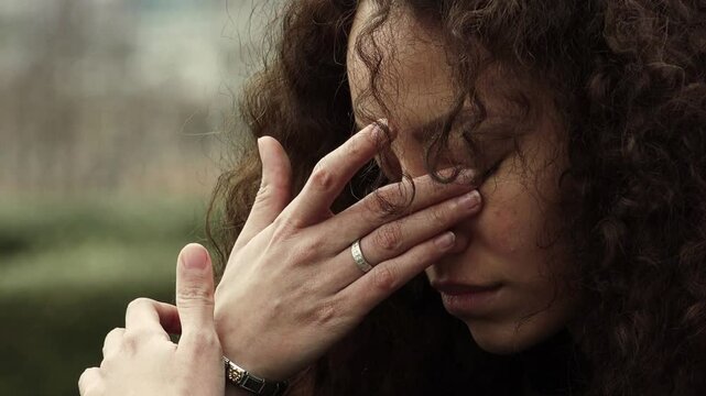 portrait of a sad depressed woman crying and drying tears from her face