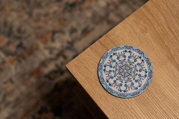 Blue coaster with Arabic and Indian patterns.