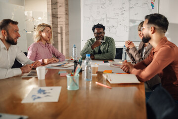 Marketing professionals collaborating on project during meeting