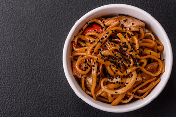 Delicious Asian food udon with noodles, chicken, hot pepper, vegetables