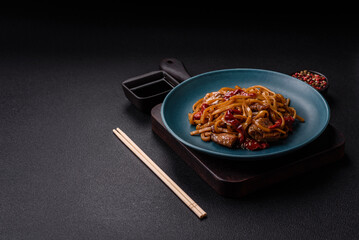 Delicious Asian food udon with noodles, chicken, hot pepper, vegetables