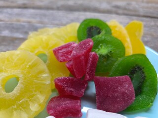 pieces of various dried candied fruits are on a plate
