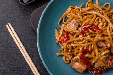 Delicious Asian food udon with noodles, chicken, hot pepper, vegetables